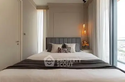 Luxurious bedroom with elegant decor and large windows offering stunning city views.