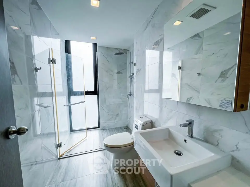 Modern bathroom with glass shower and sleek fixtures