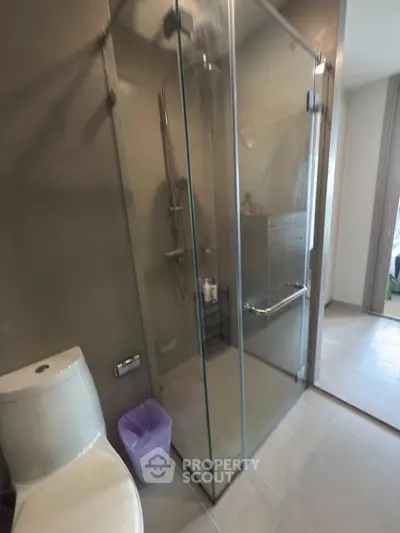 Modern bathroom with glass shower enclosure and sleek fixtures