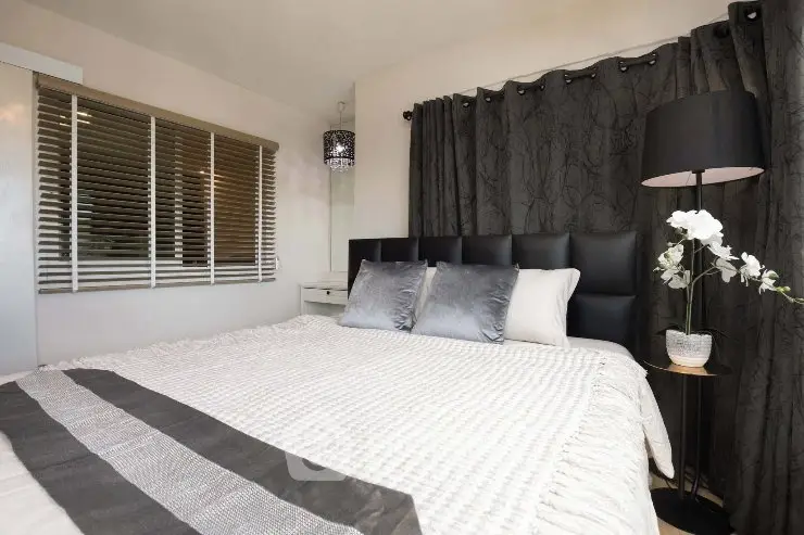 Cozy bedroom with elegant decor and plush bedding, perfect for relaxation.