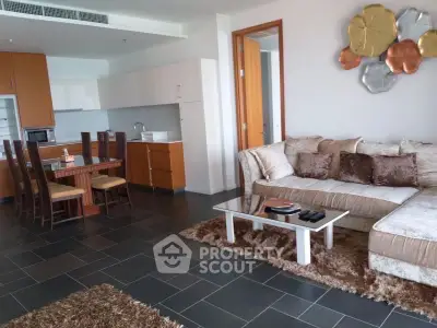 Spacious living room with modern decor and open kitchen layout in a stylish apartment.