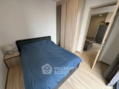 Modern bedroom with wooden flooring and sleek furniture design