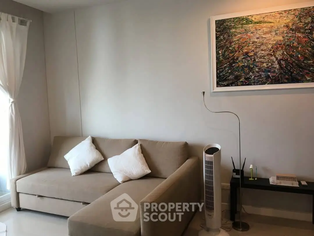 Cozy living room with modern sofa and artistic wall painting