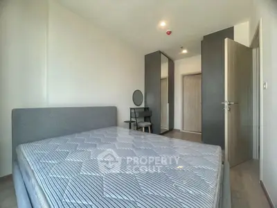 Spacious bedroom with modern decor and large bed in a stylish apartment.