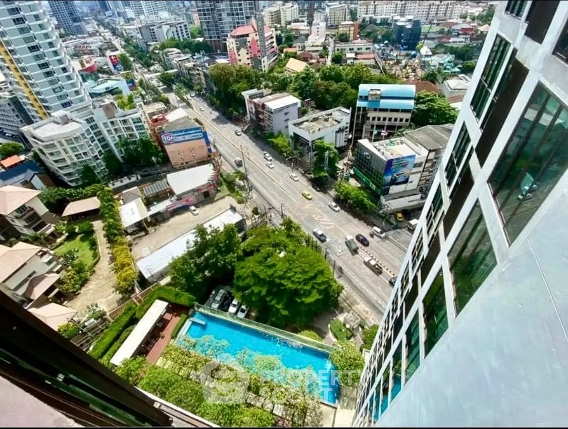Stunning high-rise view with pool and cityscape, perfect for urban living.
