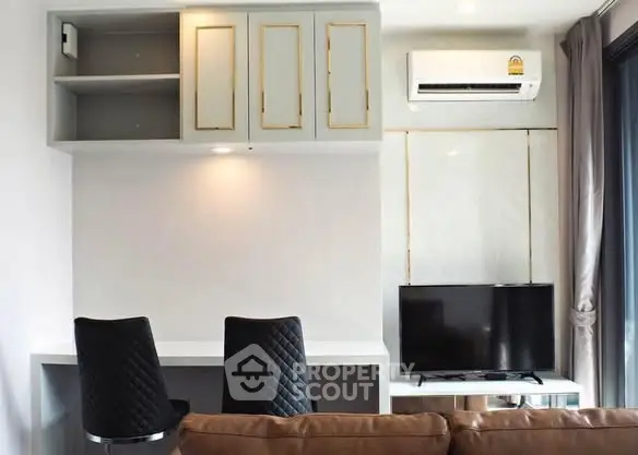 Modern living room with stylish furniture and wall-mounted TV