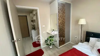 Cozy bedroom with modern decor and stylish closet in a well-lit apartment