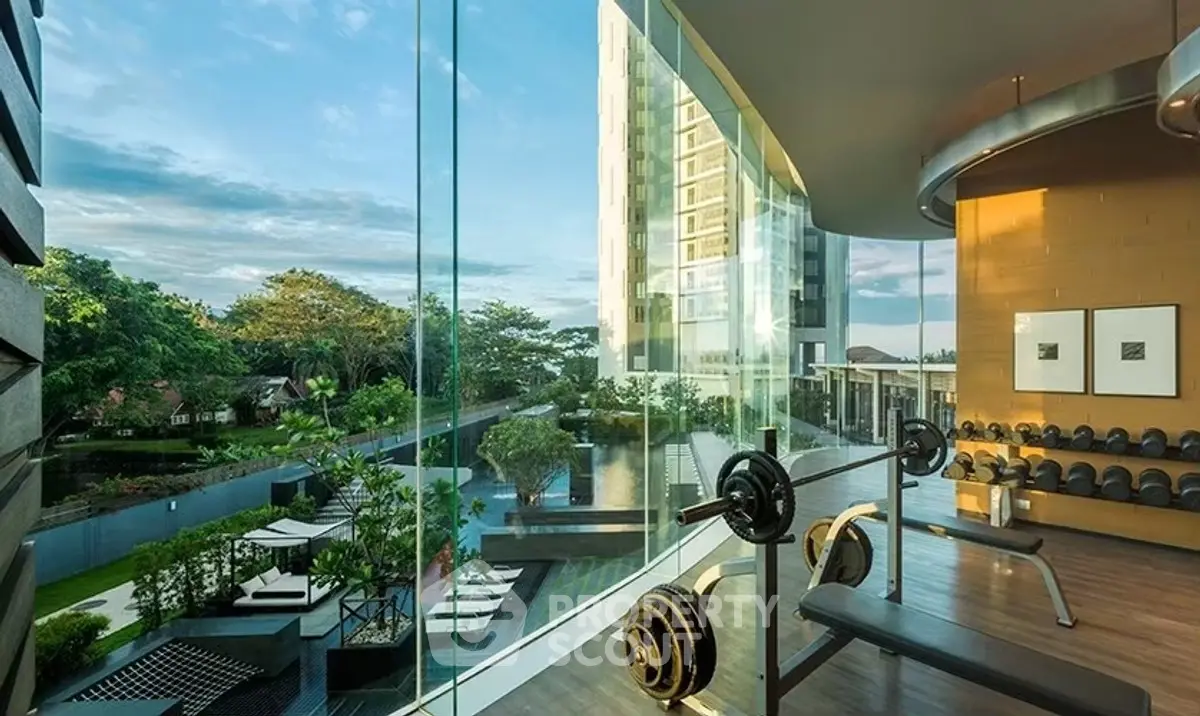 Luxurious gym with panoramic view of pool and garden in modern building