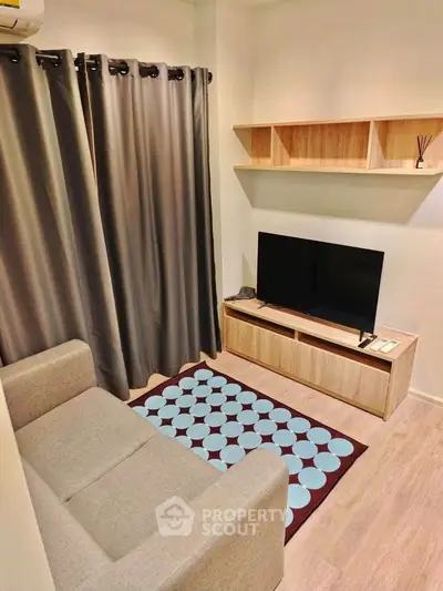 Cozy living room with modern decor, featuring a comfortable sofa, stylish TV stand, and elegant shelving.