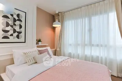 Cozy bedroom with modern decor and large window for natural light