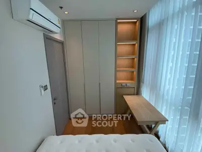 Modern bedroom with built-in wardrobe and large window