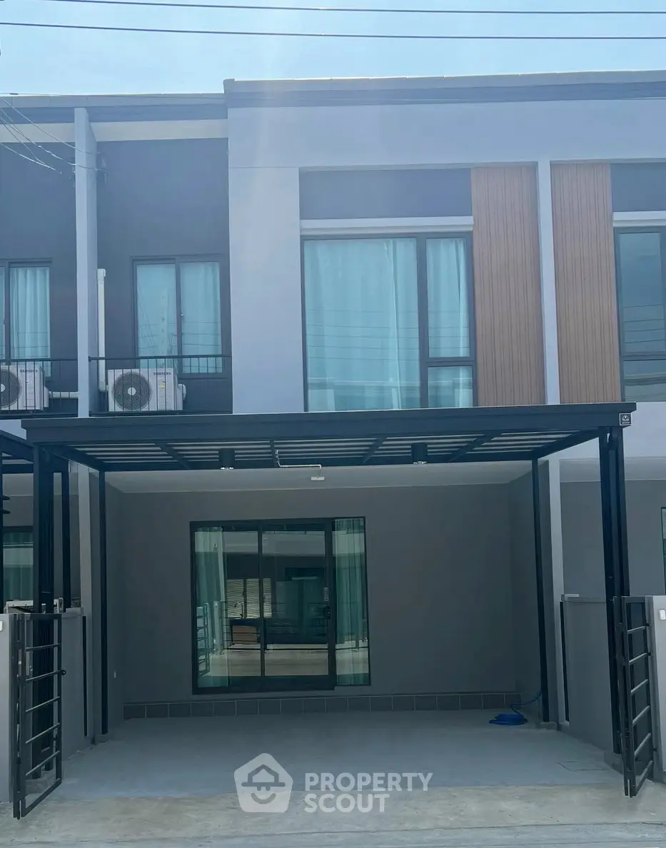 Modern townhouse exterior with sleek design and spacious carport