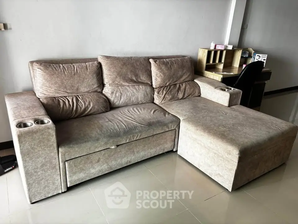 Spacious living room with plush sectional sofa and modern workspace