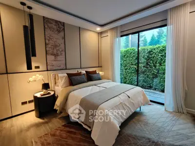 Luxurious bedroom with elegant decor and garden view, perfect for serene living.