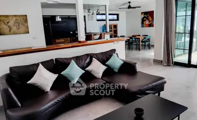 Spacious modern living room with stylish decor and open layout, featuring a comfortable sectional sofa and dining area.