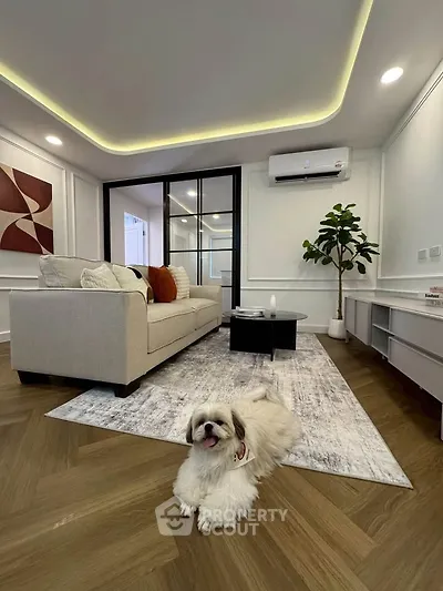Elegant living room with modern decor and cozy ambiance, featuring a plush sofa and stylish flooring.