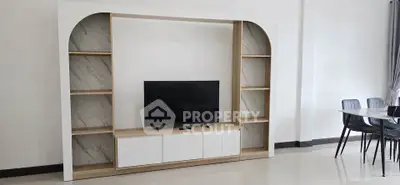 Modern living room with stylish TV unit and elegant dining area