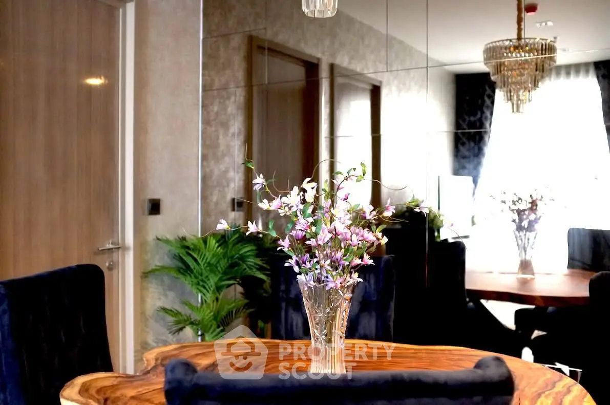Elegant dining area with wooden table and floral centerpiece, luxurious decor