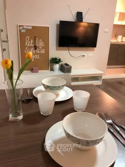 Cozy living room with modern decor and dining setup, perfect for relaxation and entertaining.