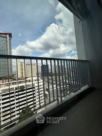 Spacious balcony with city skyline view, perfect for urban living enthusiasts.