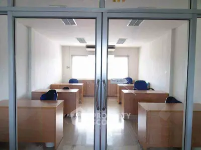 Spacious office space with modern desks and chairs, ideal for a productive work environment.