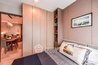 Modern bedroom with sleek design and view into dining area