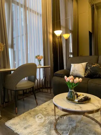 Luxurious living room with elegant decor and cozy ambiance, featuring plush seating and stylish lighting.