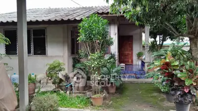 Charming single-story home with lush garden and inviting entrance, perfect for nature lovers.