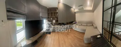 Spacious modern living room with sleek furniture and wooden flooring