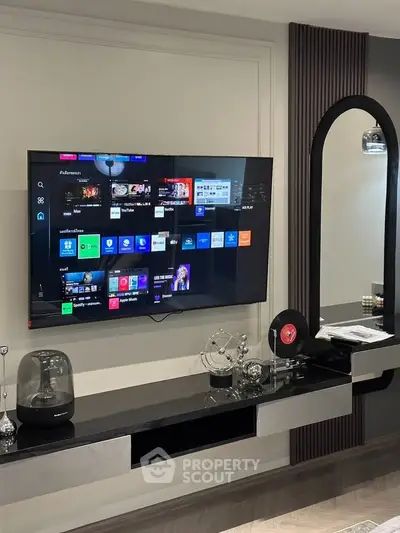 Modern living room with sleek TV setup and stylish decor elements.