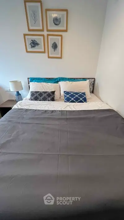 Cozy bedroom with stylish decor and comfortable bedding in modern apartment.