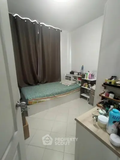 Cozy bedroom with natural light and organized storage solutions