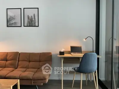 Modern living room with stylish sofa and cozy study area featuring a sleek desk and chair.