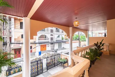 Charming balcony with elegant railing and street view in a residential area.