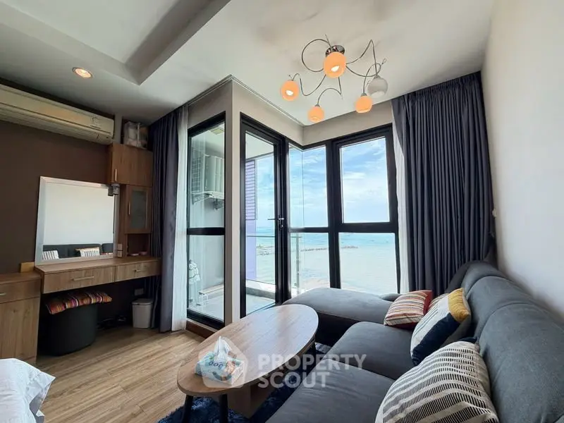 Stunning living room with ocean view, modern decor, and cozy seating area.