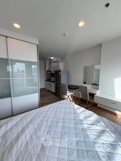 Modern studio apartment with sleek kitchen and cozy dining area