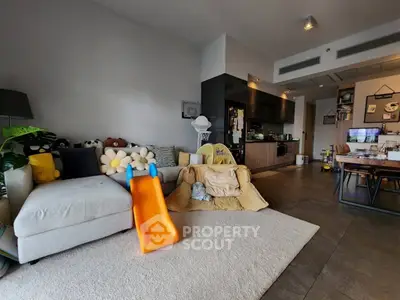 Spacious living room with modern decor and cozy play area, perfect for family living.