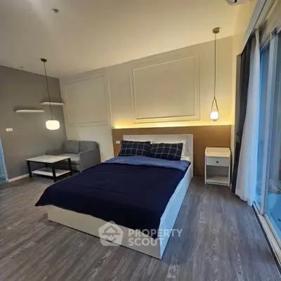 Modern bedroom with stylish decor and large windows for natural light.