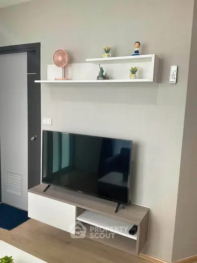 Modern living room with sleek TV stand and decorative shelves