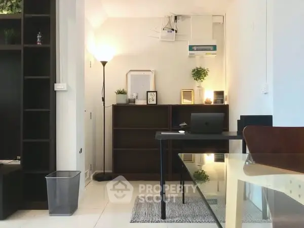 Modern home office with sleek desk, stylish shelving, and ambient lighting.
