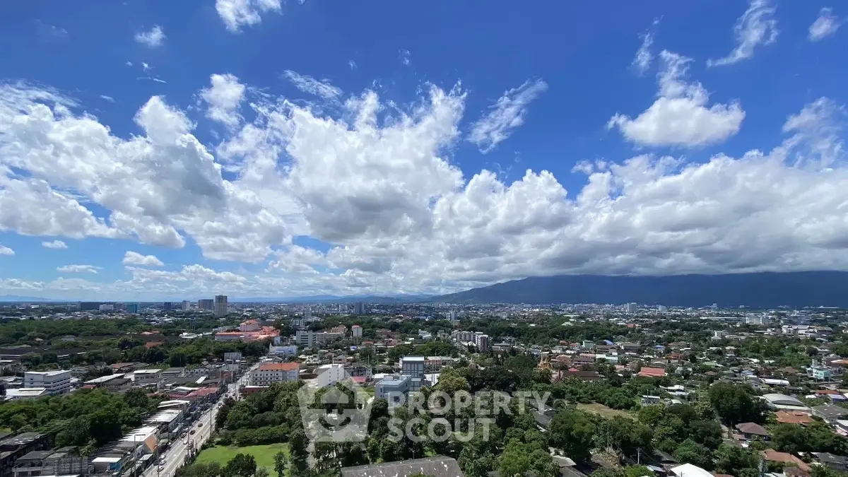 Stunning panoramic cityscape view with lush greenery and vibrant skyline under a bright blue sky.