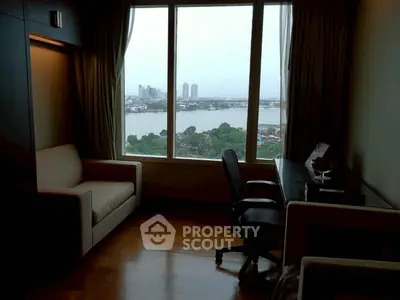 Stunning river view from modern study room with sleek desk and comfortable seating.