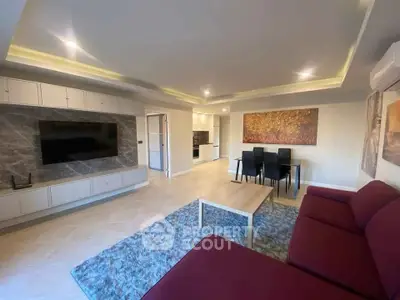 Spacious modern living room with elegant decor and open kitchen layout.