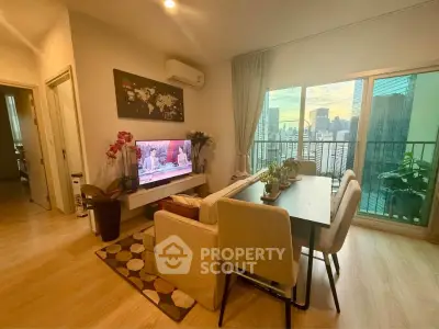Modern living room with city view balcony, stylish decor, and cozy seating area.