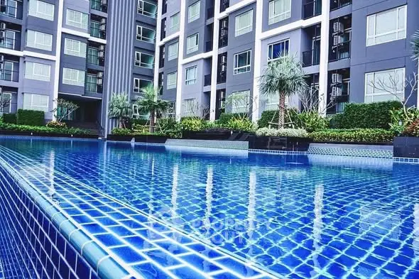 Luxurious apartment complex with stunning outdoor pool and modern architecture.