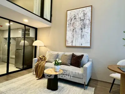 Modern living room with stylish decor and cozy ambiance, featuring a comfortable sofa and elegant artwork.