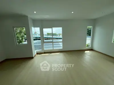 Spacious room with large windows offering a scenic view, perfect for a bright and airy living space.