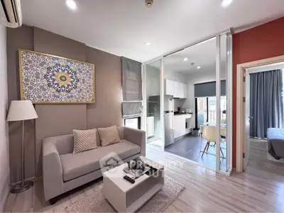 Modern living room with open kitchen and stylish decor in a cozy apartment.