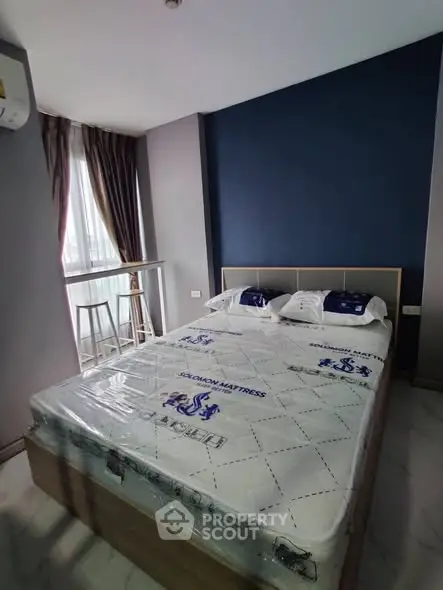 Modern bedroom with stylish decor and natural light, featuring a comfortable bed and elegant curtains.