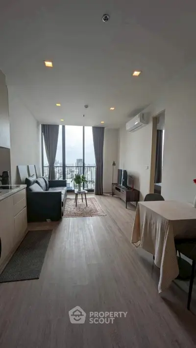 Modern living room with city view, open layout, and stylish decor
